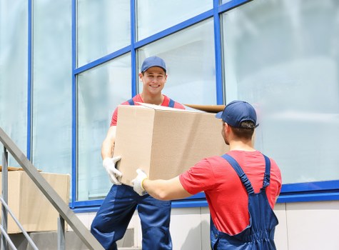 Piano removal specialists planning a move in a Pimlico street