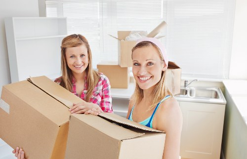 Professional movers handling household belongings carefully